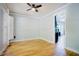 Bright living room featuring hardwood floors, ceiling fan, and view to the kitchen at 1097 Trentini Ave, Wake Forest, NC 27587