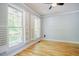 Bright living room featuring hardwood floors, white shutters and view to the front porch at 1097 Trentini Ave, Wake Forest, NC 27587