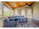 Cozy screened porch with wood ceiling, comfortable seating, and picturesque views at 1097 Trentini Ave, Wake Forest, NC 27587