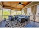 Cozy screened porch with wood ceiling, comfortable seating, and picturesque views at 1097 Trentini Ave, Wake Forest, NC 27587