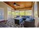 Cozy screened porch with wood ceiling, comfortable seating, and picturesque views at 1097 Trentini Ave, Wake Forest, NC 27587