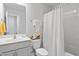 Bright bathroom with a white vanity, toilet, shower with curtain and decorative towels at 1109 Banworth Ct, Mebane, NC 27302