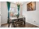 Inviting dining area with modern chandelier, table with seating and a serene window view at 1109 Banworth Ct, Mebane, NC 27302