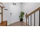 Bright entryway featuring wood floors, a white door, and coat rack with stairs nearby at 1109 Banworth Ct, Mebane, NC 27302