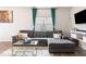 Cozy living room with a comfortable gray sectional sofa, stylish decor, and a large window at 1109 Banworth Ct, Mebane, NC 27302