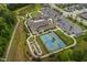 Aerial view of neighborhood recreational center, featuring tennis courts, walking trail, and parking area at 1129 Santa Cruz St, Wake Forest, NC 27587