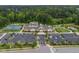 Aerial view of neighborhood recreational center, featuring tennis courts, walking trail, and parking area at 1129 Santa Cruz St, Wake Forest, NC 27587