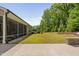 Lush backyard featuring a serene screened porch, expansive lawn, and meticulously landscaped borders at 1129 Santa Cruz St, Wake Forest, NC 27587