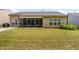 Expansive backyard with lush green lawn, a screened porch, and a well-maintained exterior at 1129 Santa Cruz St, Wake Forest, NC 27587