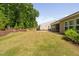 Picturesque backyard with mature trees, a well-kept lawn, and a glimpse of the home's screened-in porch at 1129 Santa Cruz St, Wake Forest, NC 27587