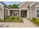 The front porch of the home has lovely landscaping, includes rocking chairs and a decorative flower pot at 1129 Santa Cruz St, Wake Forest, NC 27587
