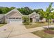 Charming one-story home boasts a well-kept lawn, landscaped garden beds, and an attached two-car garage at 1129 Santa Cruz St, Wake Forest, NC 27587