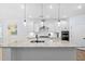 Bright kitchen features granite countertops, stainless steel appliances, pendant lighting, and white cabinetry at 1129 Santa Cruz St, Wake Forest, NC 27587