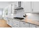 This kitchen features granite counters, white subway tile backsplash, stainless range hood, and ample cabinet space at 1129 Santa Cruz St, Wake Forest, NC 27587