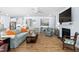 Spacious living room with hardwood floors, fireplace and seamless flow into the open kitchen at 1129 Santa Cruz St, Wake Forest, NC 27587