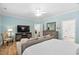 Bright main bedroom features hardwood floors, a ceiling fan and light blue walls at 1129 Santa Cruz St, Wake Forest, NC 27587