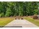 Spacious patio perfect for outdoor entertaining, with a view of the beautifully landscaped backyard and mature trees at 1129 Santa Cruz St, Wake Forest, NC 27587