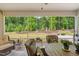 The screened porch offers a peaceful view of the beautifully landscaped backyard at 1129 Santa Cruz St, Wake Forest, NC 27587