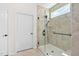 Tiled shower featuring a black shower head, glass enclosure, and a small window at 1129 Santa Cruz St, Wake Forest, NC 27587