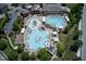 Aerial view of community pool, amenities, and clubhouse with surrounding homes and lush landscaping at 1141 Brookhill Way, Cary, NC 27519