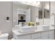 Bright bathroom featuring a double vanity with white square sinks and modern chrome faucets at 1141 Brookhill Way, Cary, NC 27519