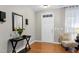 Elegant entryway with hardwood floors, decorative mirror, and stylish accents, offering a warm welcome to guests at 1141 Brookhill Way, Cary, NC 27519