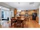 Open kitchen seamlessly connected to dining area with backyard view, island, and appliances to enjoy a Gathering meal at 1141 Brookhill Way, Cary, NC 27519