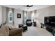 Comfortable living room with natural light and neutral tones, furniture arrangement, and a ceiling fan at 1141 Brookhill Way, Cary, NC 27519