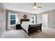 Comfortable main bedroom features a tray ceiling, neutral walls, and bright natural light at 1141 Brookhill Way, Cary, NC 27519