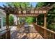 Relaxing outdoor patio with pergola and a lovely table setting, surrounded by green foliage at 1141 Brookhill Way, Cary, NC 27519