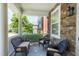 Relaxing outdoor porch with comfortable wicker seating and stylish stone flooring, perfect for enjoying fresh air at 1141 Brookhill Way, Cary, NC 27519
