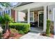 Inviting front porch with stone accents, lush landscaping, and cozy seating, creating a welcoming entrance at 1141 Brookhill Way, Cary, NC 27519