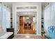 Sunroom with tile floor and view of the kitchen and stairwell through glass doors at 1141 Brookhill Way, Cary, NC 27519