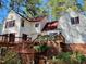 A grand home's back exterior showcasing wood lattice under the deck and an inviting staircase at 11813 Edgewater Ct, Raleigh, NC 27614