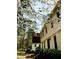 Exterior of a home with white siding, a red roof, and blooming dogwood trees in the yard at 11813 Edgewater Ct, Raleigh, NC 27614