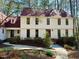 A white two-story home with red window trim and a well-maintained front garden at 11813 Edgewater Ct, Raleigh, NC 27614