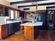 Spacious kitchen featuring an island, stainless appliances, and wooden beams at 11813 Edgewater Ct, Raleigh, NC 27614