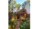 Multi-level deck and lush garden featuring vibrant flowers and greenery at 11813 Edgewater Ct, Raleigh, NC 27614