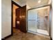 Bathroom featuring a glass-enclosed shower with tiled walls, complemented by a stylish door and neutral flooring at 11813 Edgewater Ct, Raleigh, NC 27614