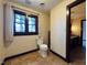 Bathroom featuring a classic white toilet, a window for natural light, and a vanity with ample storage at 11813 Edgewater Ct, Raleigh, NC 27614