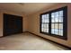 Bedroom featuring plush carpeting, neutral walls, natural lighting, and a closet at 11813 Edgewater Ct, Raleigh, NC 27614