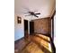 Bedroom with hardwood floors, ceiling fan, and a decorative brick wall adding character to the space at 11813 Edgewater Ct, Raleigh, NC 27614