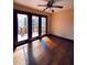 This bedroom boasts hardwood floors, a ceiling fan, and access to a private balcony with wooded views at 11813 Edgewater Ct, Raleigh, NC 27614
