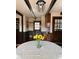 Dining area featuring wood floors, wainscotting, wooden cabinetry and a vintage light fixture at 11813 Edgewater Ct, Raleigh, NC 27614