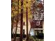 Exterior of home featuring seasonal leaves, red roof, and mature trees at 11813 Edgewater Ct, Raleigh, NC 27614