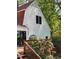 Charming home exterior, featuring a wooden deck with climbing roses and a peaceful view at 11813 Edgewater Ct, Raleigh, NC 27614