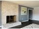 Living room fireplace with decorative brick surround at 11813 Edgewater Ct, Raleigh, NC 27614