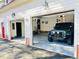 Spacious three car garage featuring painted floors, brick accents and updated lighting; perfect for car enthusiasts or a workshop at 11813 Edgewater Ct, Raleigh, NC 27614