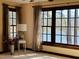 This living room offers lake views, hardwood floors, a decorative lamp, and neutral-toned curtains at 11813 Edgewater Ct, Raleigh, NC 27614