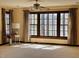 Bright living room with large windows offering picturesque views of the lake, complemented by stylish curtains at 11813 Edgewater Ct, Raleigh, NC 27614